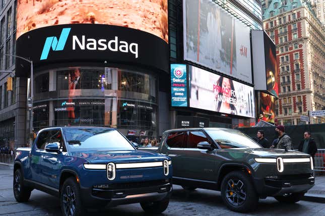Rivian’s electric trucks sit in front of the Nasdaq MarketSite building as it went public in November 2021.