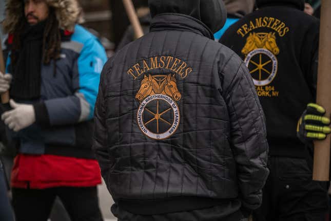 A Teamsters jacket is worn as Amazon workers and union members picket outside a distribution center in the Queens, New York, US, on Friday, Dec. 20, 2024.