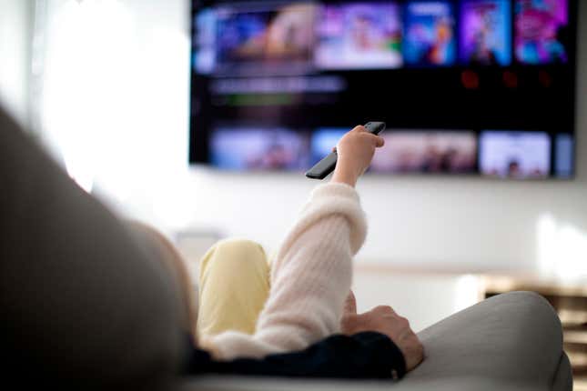 Family watching TV at home. 