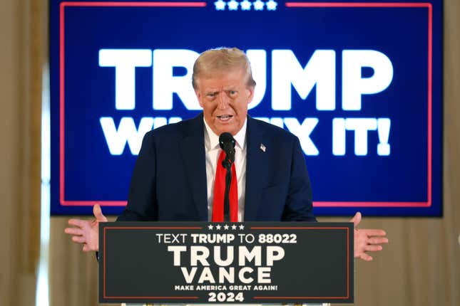 President-elect Donald Trump speaks at a podium in front of Trump/Vance signs